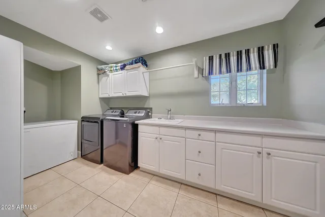 a kitchen with granite countertop a stove a sink and a refrigerator