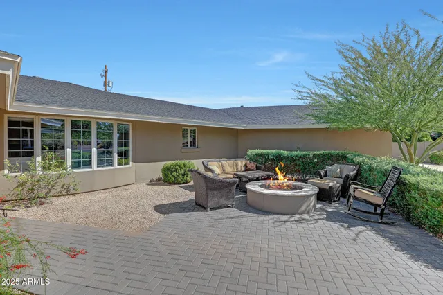 a front view of a house with sitting area