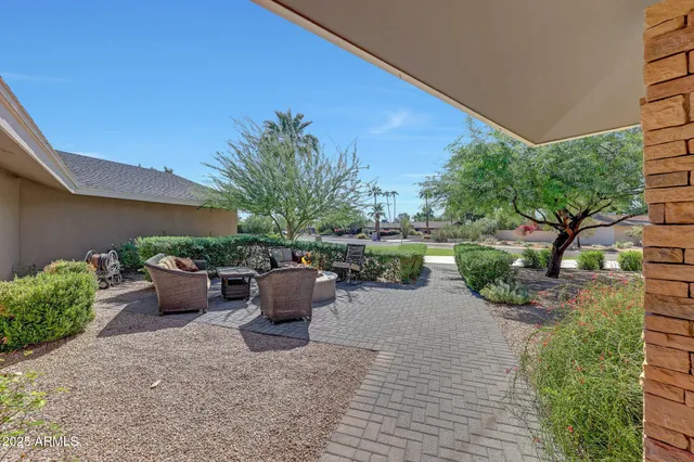 a view of a backyard with sitting area