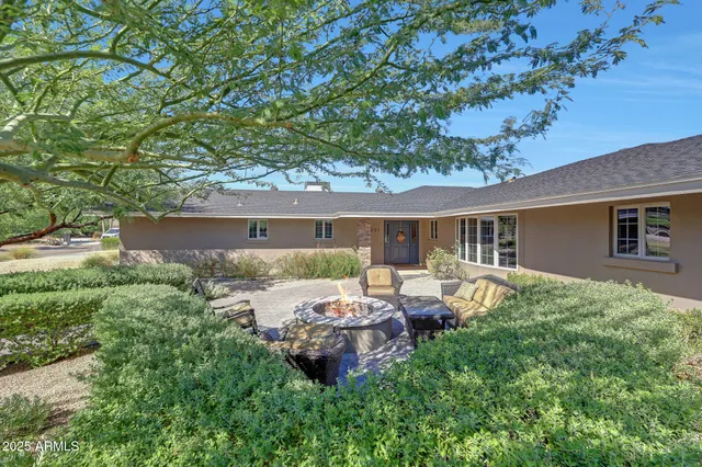 a view of house with backyard