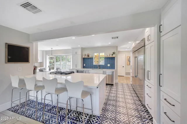 a large kitchen with dining table and chairs