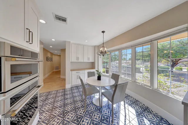 a dining room with furniture a rug and wooden floor