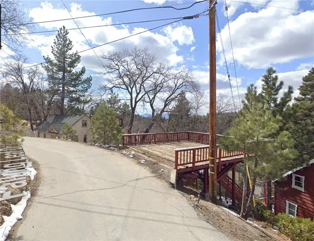 a view of a street with a tree on the side of it