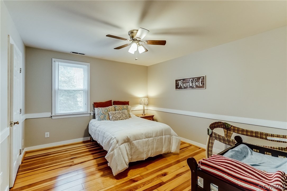 9000 Cardiff Road North Chesterfield, VA 23236 - Photo 29 of 40 a bedroom with a bed and wooden floor