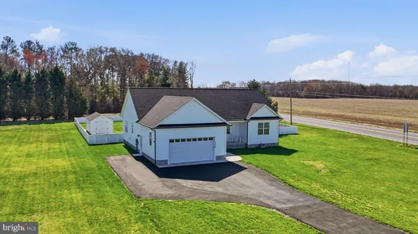 a aerial view of a house with a yard table and chairs