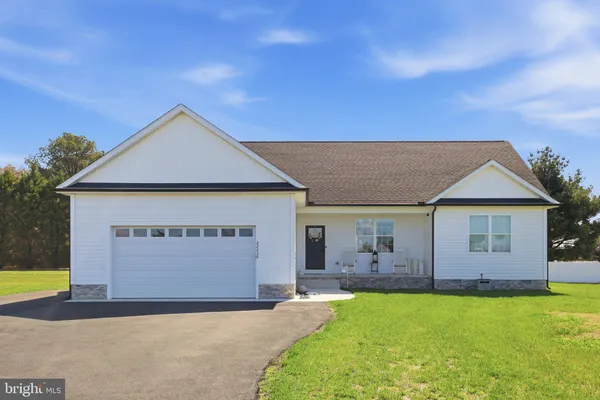 a view of house with backyard and a garden