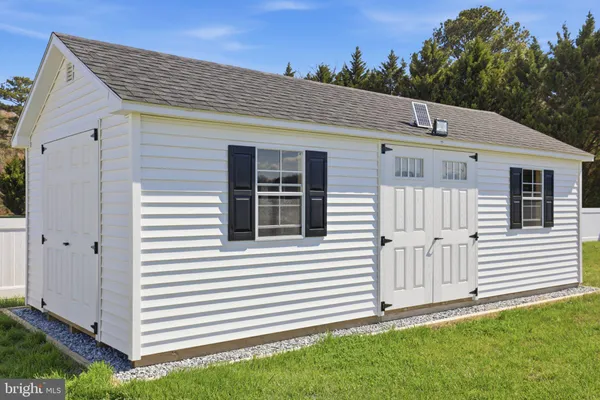 a view of a house with a yard and garage