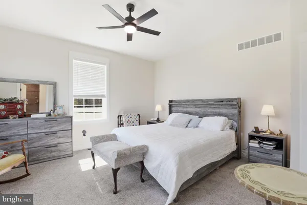 a bedroom with a bed and a couch