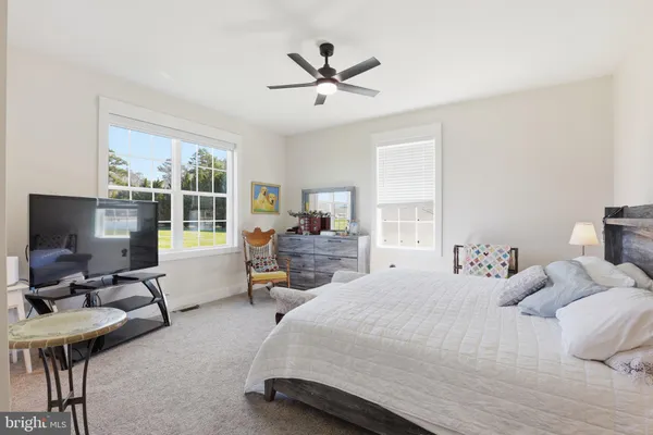 a bedroom with a bed and a desk