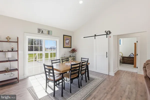 a view of a dining room with furniture and window