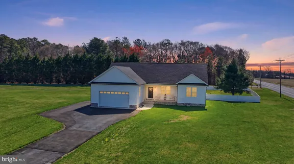 a view of a house with a yard and a garden