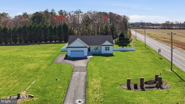 a aerial view of a house with swimming pool garden and mountain view in back