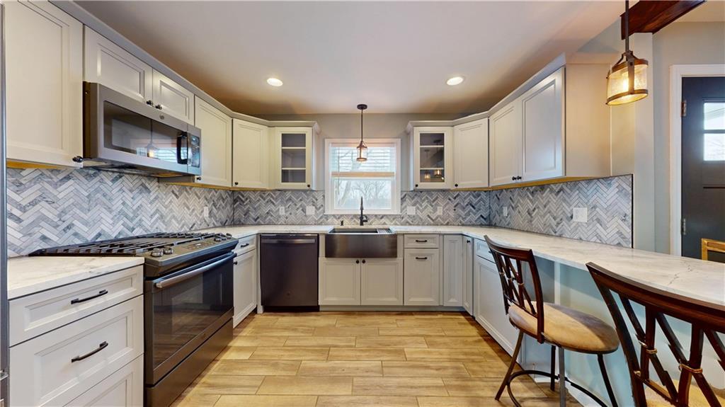 820 Sunset Drive Butler, PA 16001 - Photo 11 of 34 a kitchen with stainless steel appliances granite countertop a stove microwave and sink