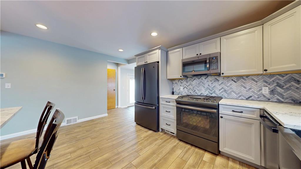 820 Sunset Drive Butler, PA 16001 - Photo 13 of 34 a kitchen with stainless steel appliances granite countertop a stove a sink and a microwave