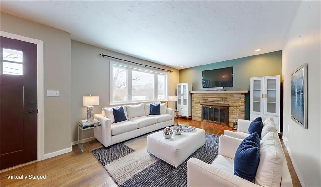 820 Sunset Drive Butler, PA 16001 - Photo 2 of 34 a living room with furniture a fireplace and a flat screen tv