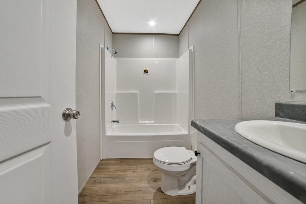 3106 Smyrna Road Sunset, TX 76270 - Photo 29 of 38 a bathroom with a toilet a sink and bathtub