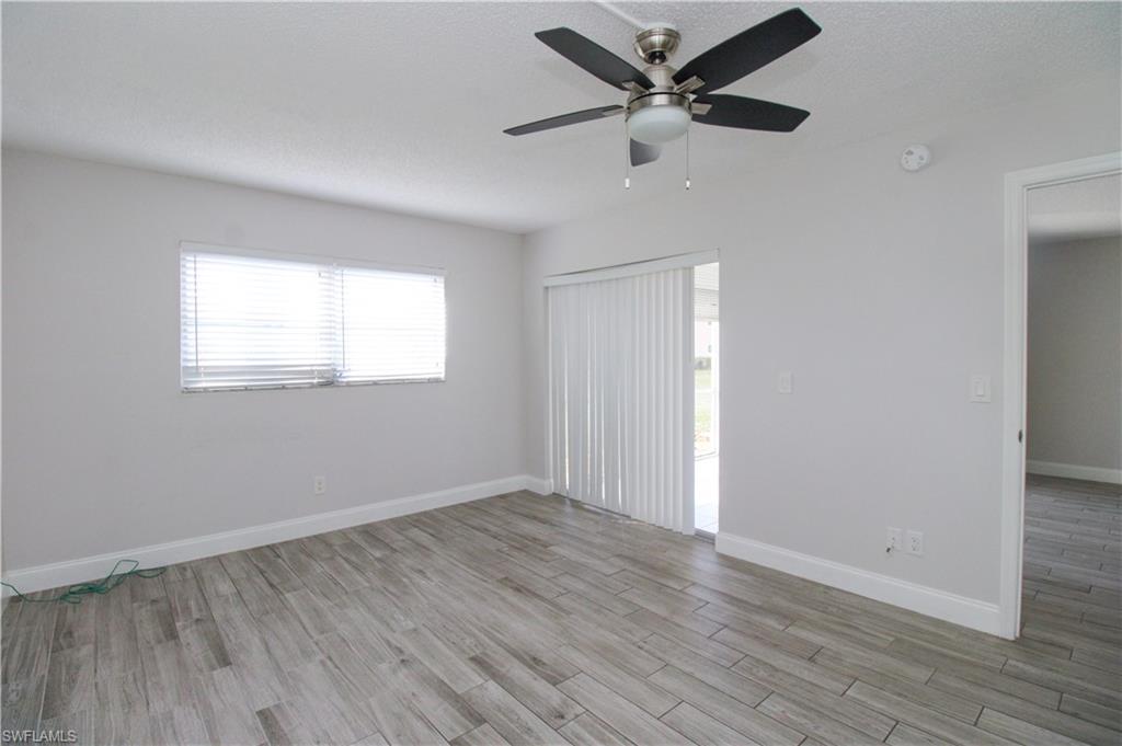 5635 Rattlesnake Hammock Road, Unit 102D Naples, FL 34113 - Photo 22 of 47 wooden floor in an empty room with a window