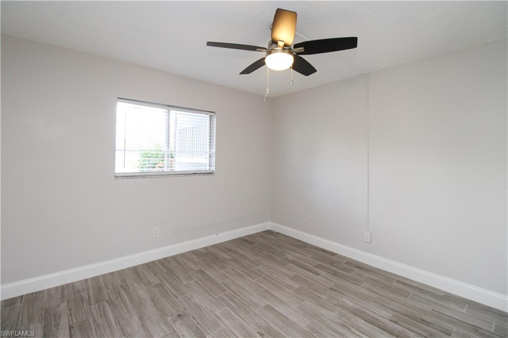 5635 Rattlesnake Hammock Road, Unit 102D Naples, FL 34113 - Photo 28 of 47 an empty room with wooden floor and windows