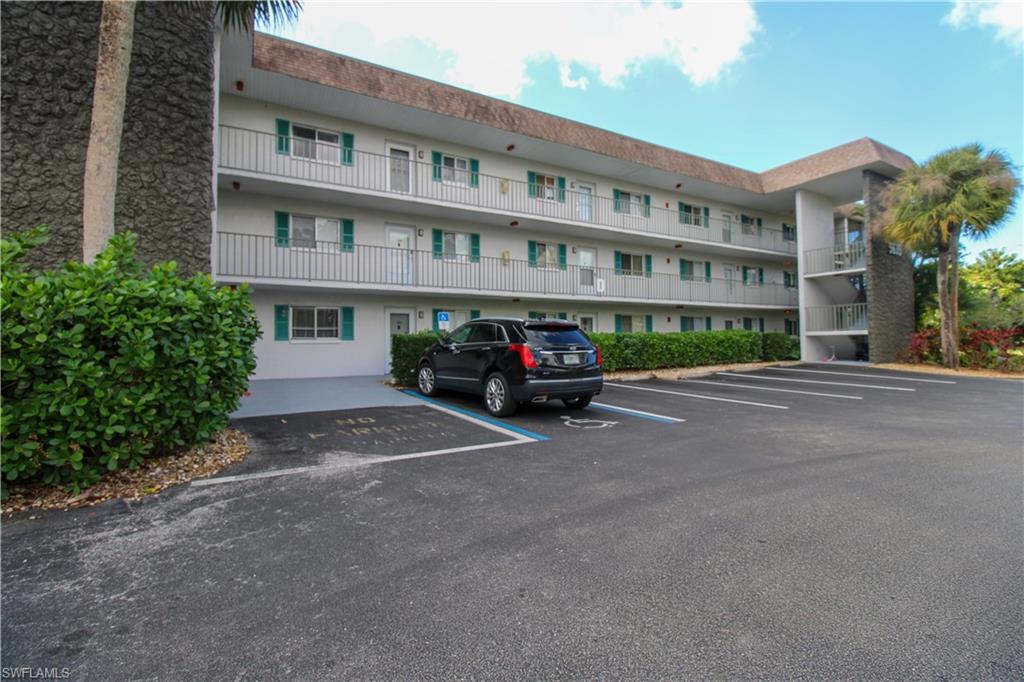 5635 Rattlesnake Hammock Road, Unit 102D Naples, FL 34113 - Photo 3 of 47 a cars parked in front of a building