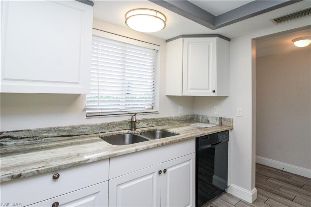 5635 Rattlesnake Hammock Road, Unit 102D Naples, FL 34113 - Photo 35 of 47 a kitchen with a sink cabinets and a window