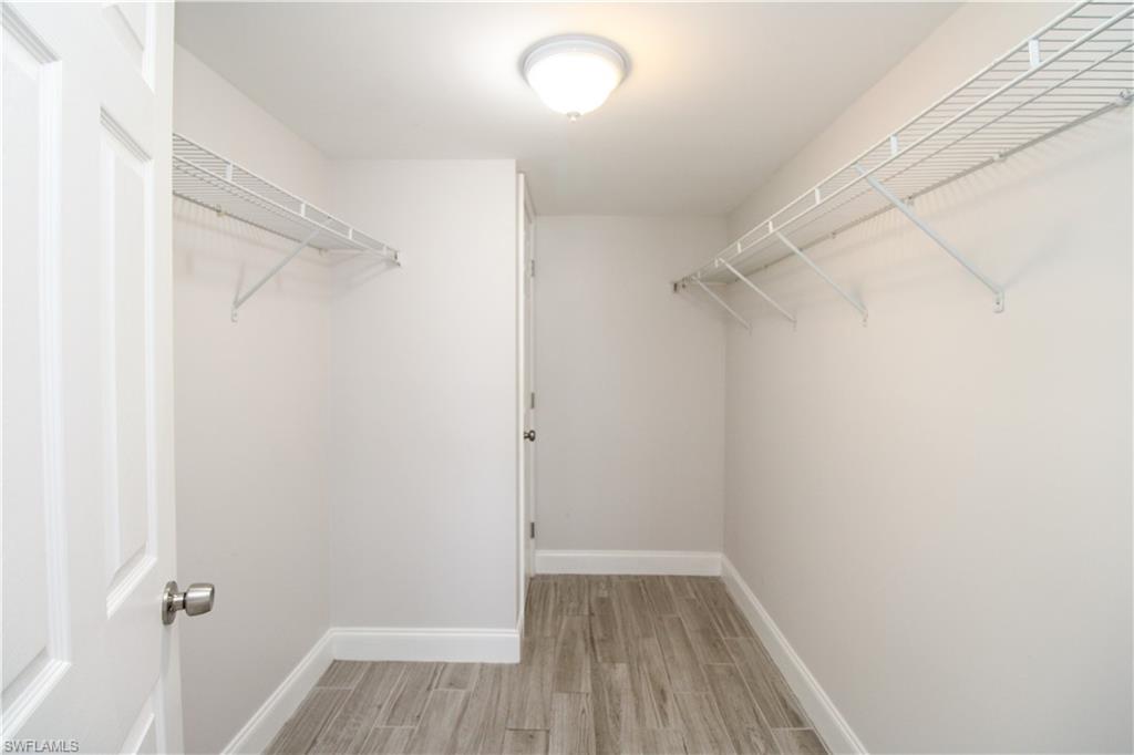 5635 Rattlesnake Hammock Road, Unit 102D Naples, FL 34113 - Photo 38 of 47 a view of a room with wooden floor and a window