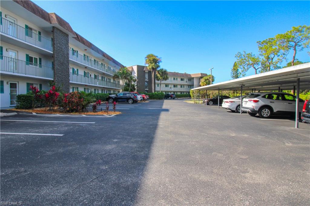 5635 Rattlesnake Hammock Road, Unit 102D Naples, FL 34113 - Photo 4 of 47 a view of street with parked cars