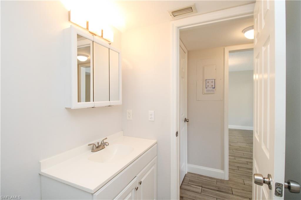 5635 Rattlesnake Hammock Road, Unit 102D Naples, FL 34113 - Photo 41 of 47 a bathroom with a sink vanity and a mirror