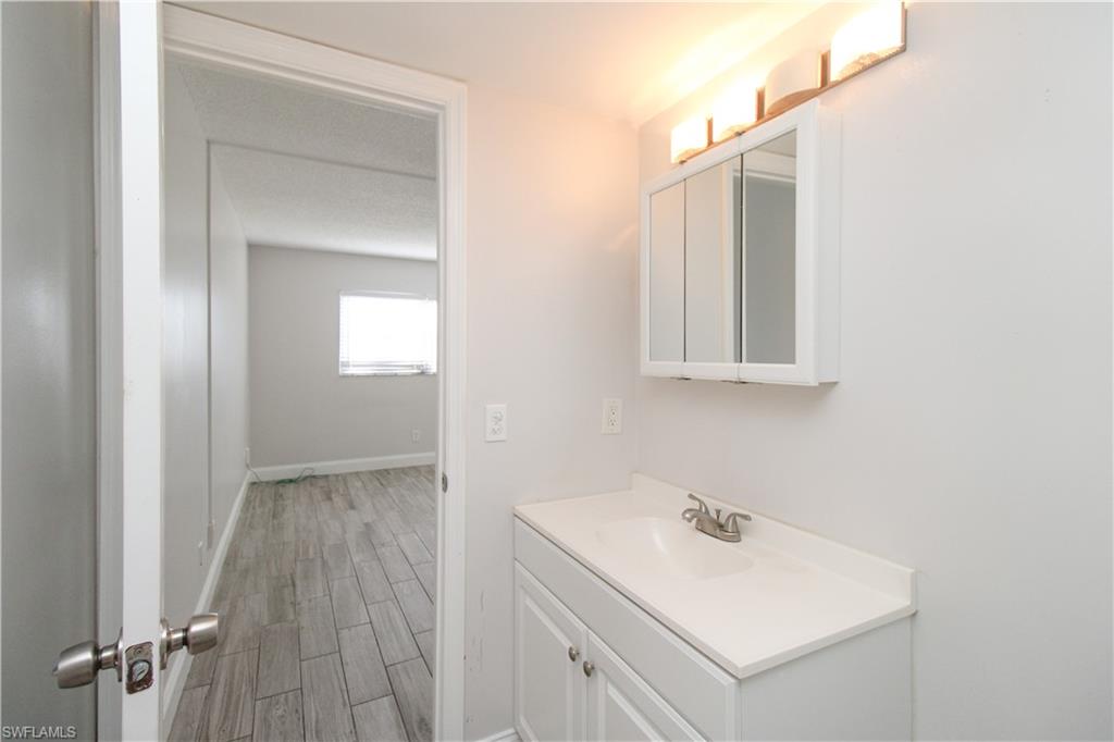 5635 Rattlesnake Hammock Road, Unit 102D Naples, FL 34113 - Photo 42 of 47 a bathroom with a sink and a mirror