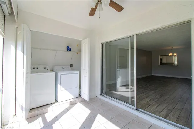 a view of a hallway with bathroom and wooden floor
