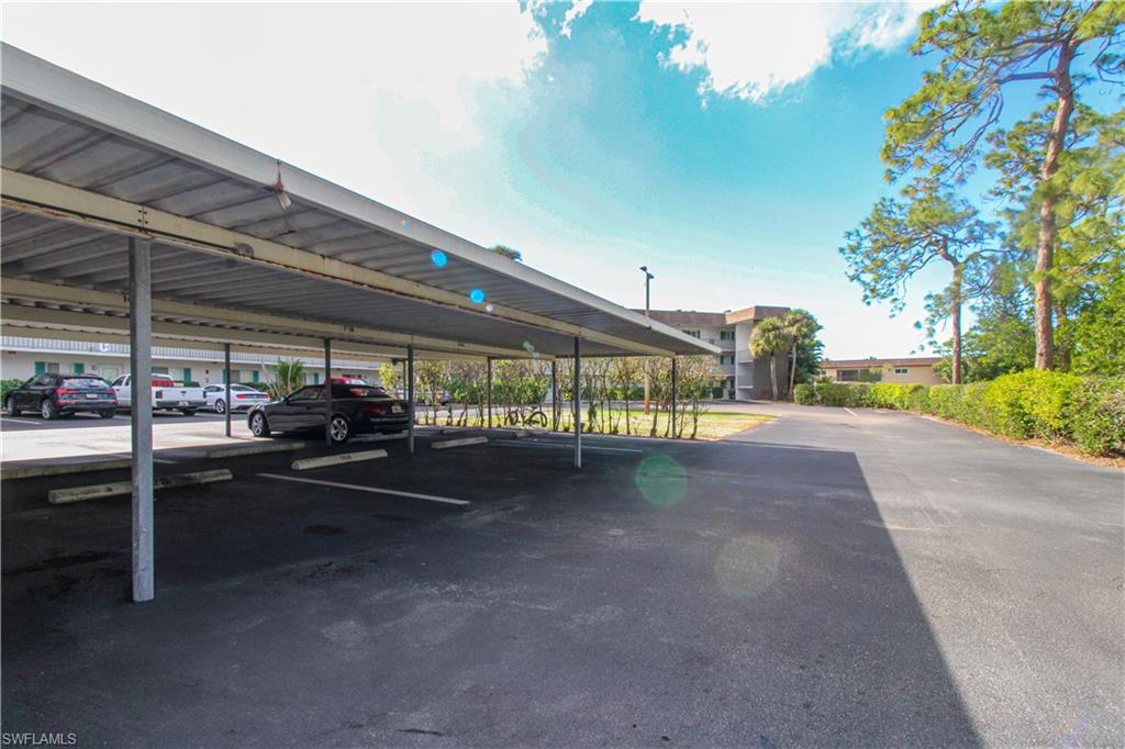5635 Rattlesnake Hammock Road, Unit 102D Naples, FL 34113 - Photo 5 of 47 a view of a street with cars
