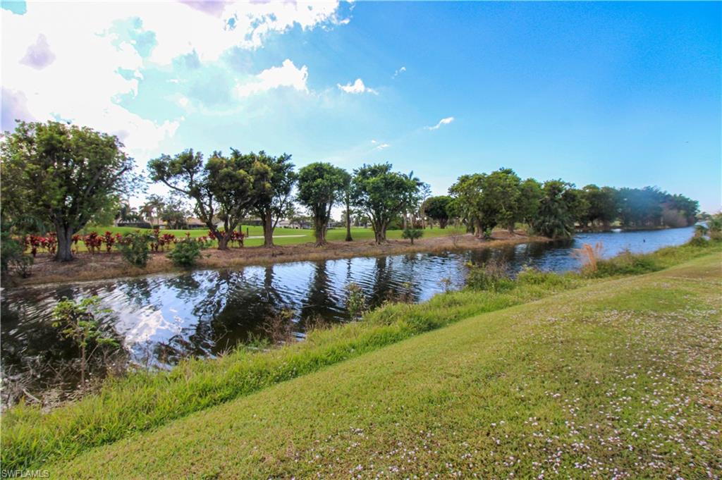 5635 Rattlesnake Hammock Road, Unit 102D Naples, FL 34113 - Photo 10 of 47 a view of a lake with houses in the back