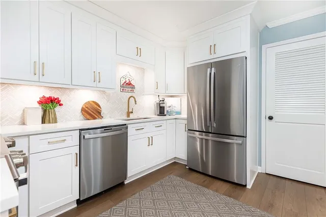 a kitchen with appliances cabinets and a window