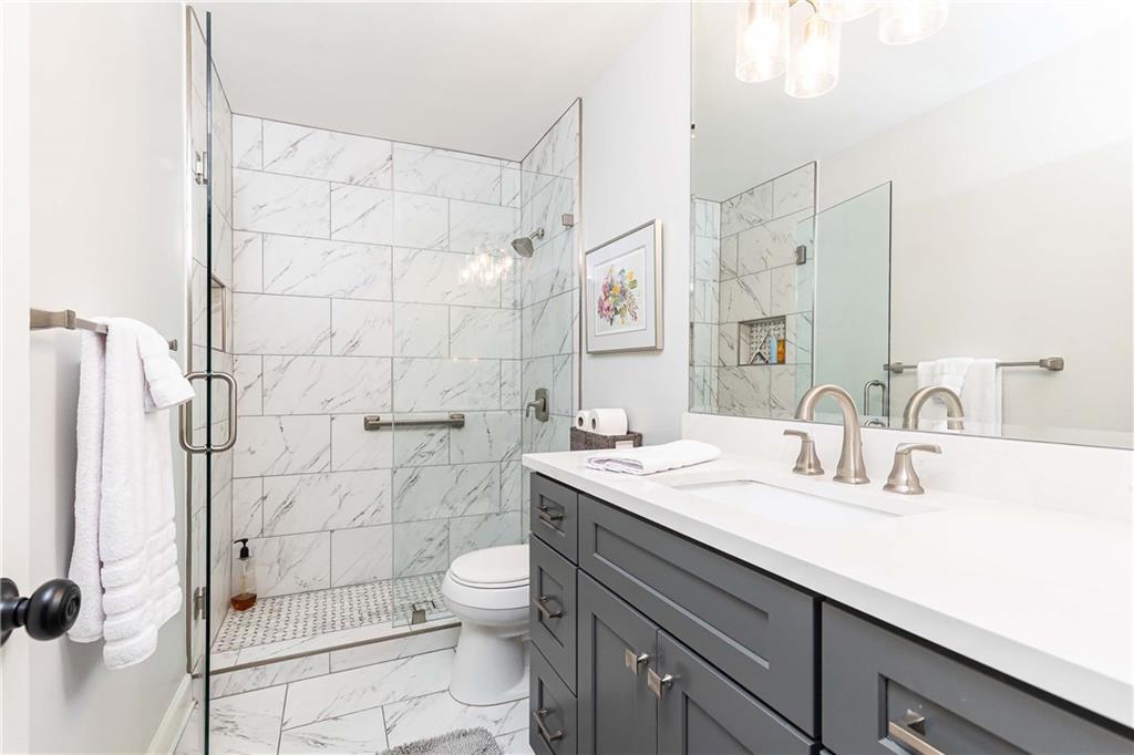 5 Middle Plantation Road Northwest, Unit 5 Atlanta, GA 30318 - Photo 20 of 33 a bathroom with a sink a toilet and shower