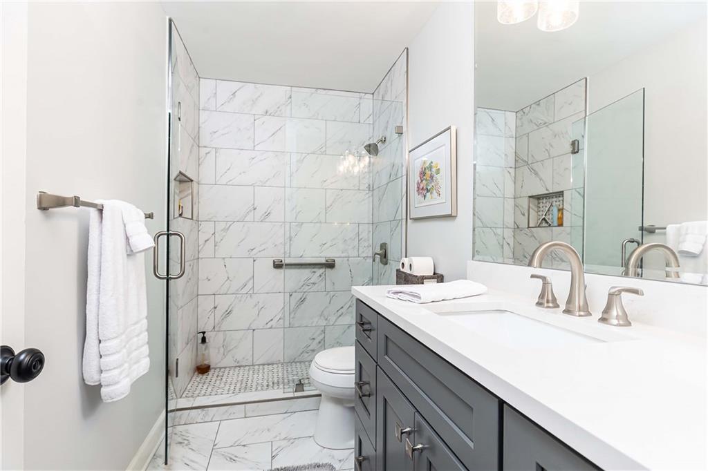 5 Middle Plantation Road Northwest, Unit 5 Atlanta, GA 30318 - Photo 21 of 33 a bathroom with a double vanity sink toilet and shower