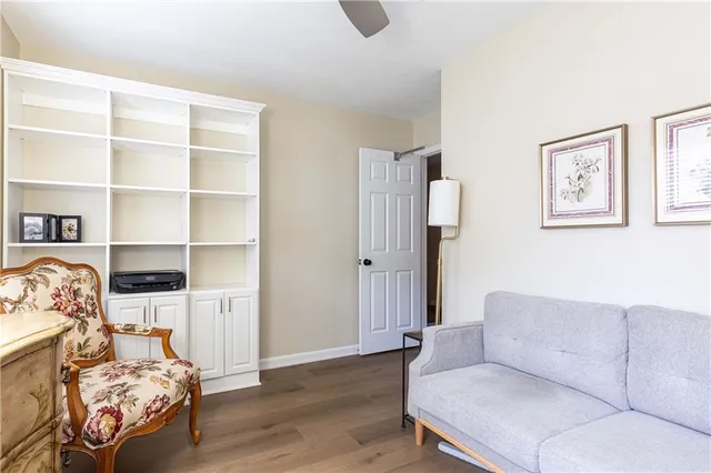 a living room with furniture and a book shelf
