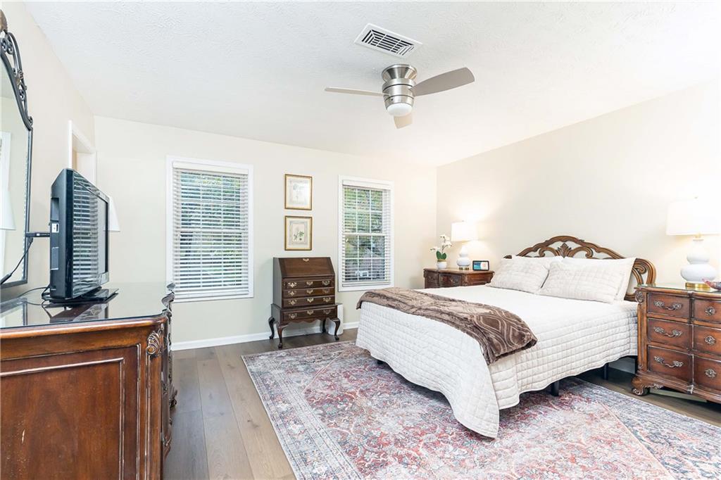 5 Middle Plantation Road Northwest, Unit 5 Atlanta, GA 30318 - Photo 24 of 33 a bedroom with a large bed and a flat tv screen on dresser