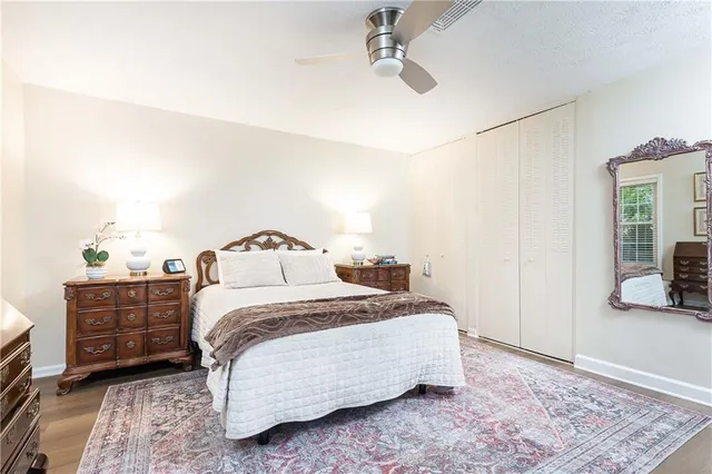 a bedroom with a bed and wooden floor