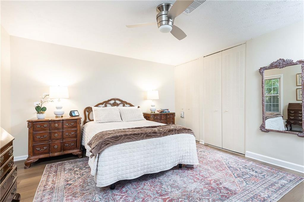 5 Middle Plantation Road Northwest, Unit 5 Atlanta, GA 30318 - Photo 25 of 33 a bedroom with a bed and wooden floor