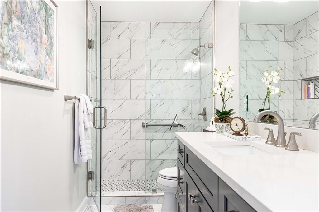 5 Middle Plantation Road Northwest, Unit 5 Atlanta, GA 30318 - Photo 28 of 33 a bathroom with a sink and a mirror