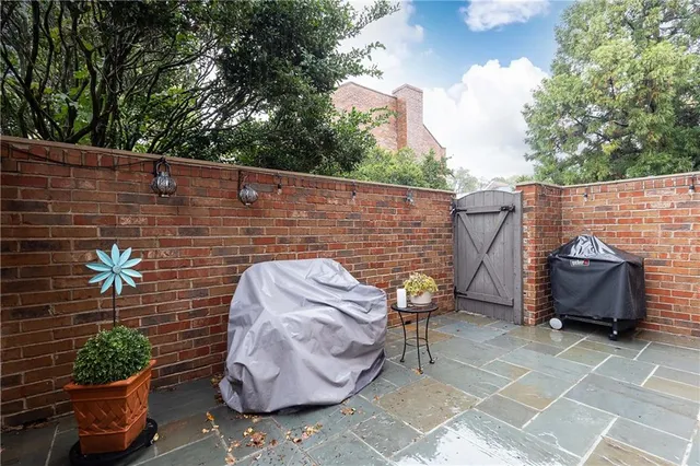 a view of patio with couple of furniture