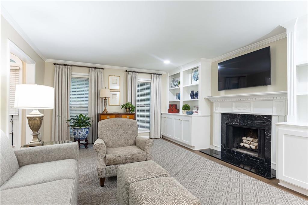 5 Middle Plantation Road Northwest, Unit 5 Atlanta, GA 30318 - Photo 6 of 33 a living room with furniture a flat screen tv and a fireplace
