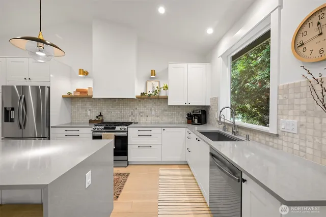 a kitchen with a sink stove and refrigerator