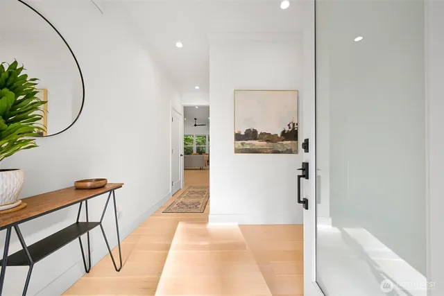 a hallway with dining room and wooden floor