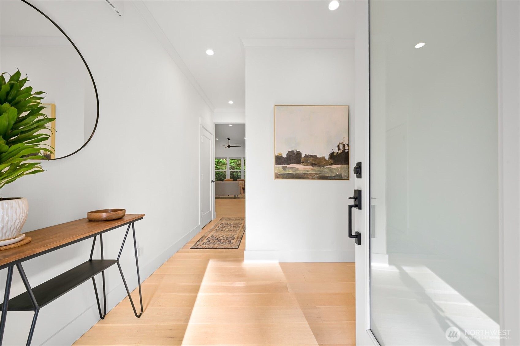 5440 Tanager Road Blaine, WA 98230 - Photo 2 of 40 a hallway with dining room and wooden floor