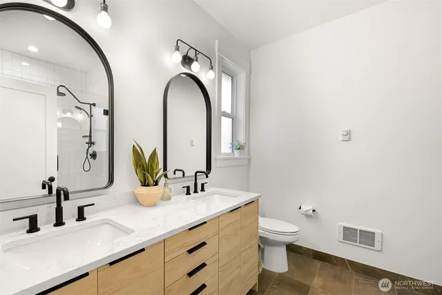 a bathroom with a double vanity sink and a mirror