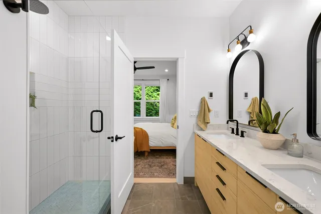 a bathroom with a double vanity sink and a mirror