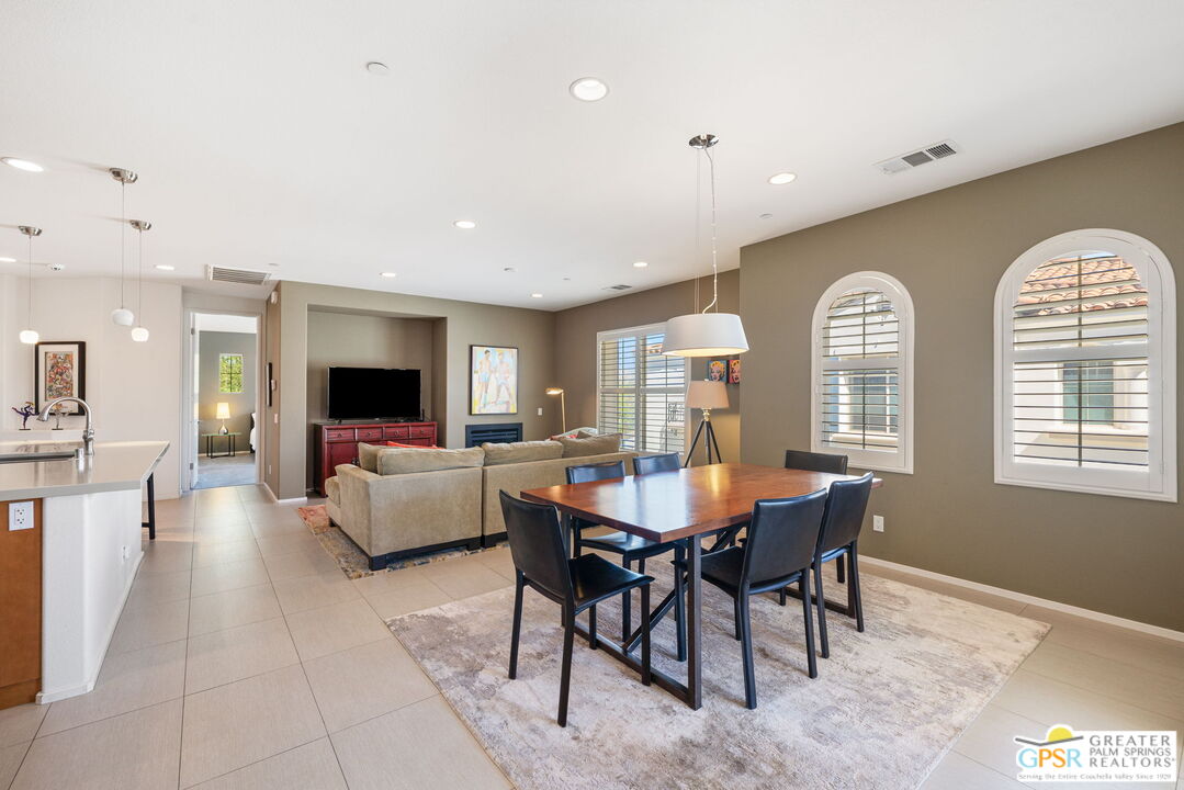 491 Terra Vita Palm Springs, CA 92262 - Photo 13 of 25 a living room with furniture a table and a large window