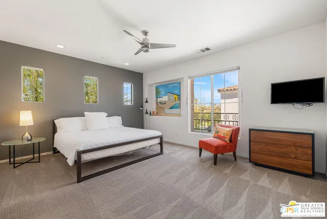 a spacious bedroom with a bed and a couch