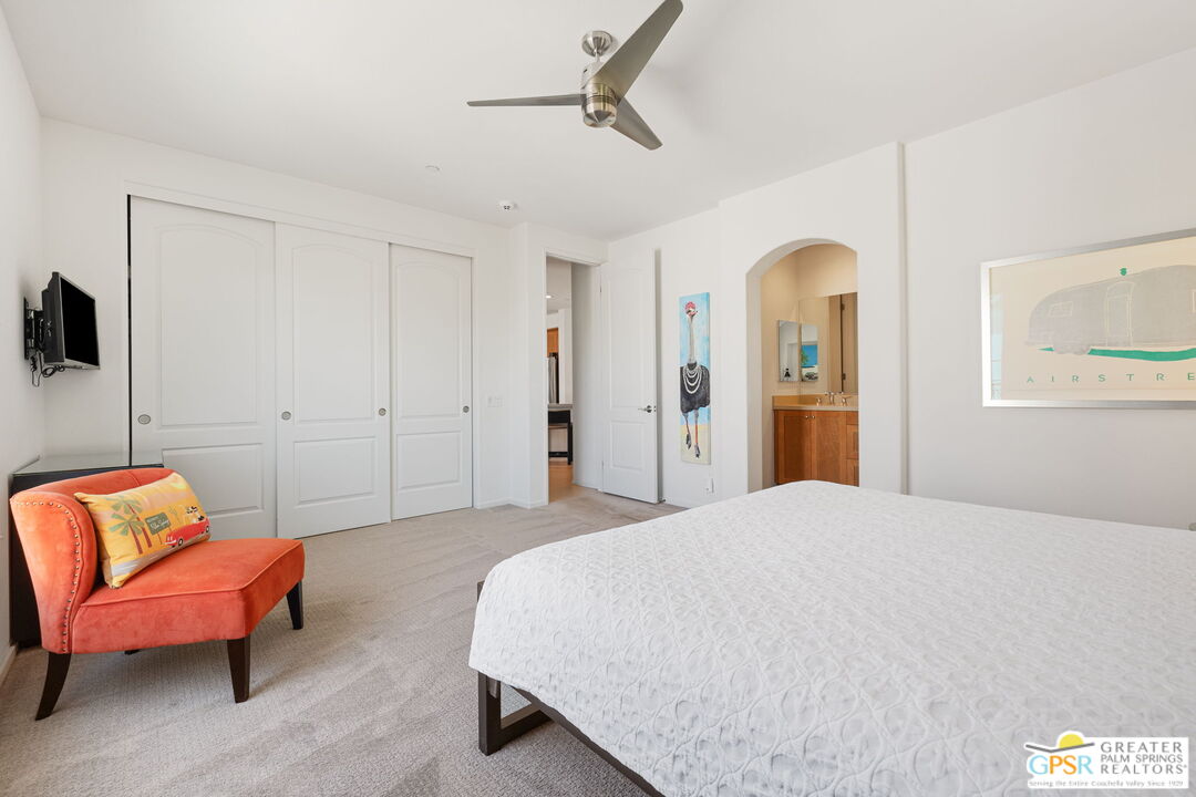491 Terra Vita Palm Springs, CA 92262 - Photo 18 of 25 a spacious bedroom with a bed and a couch