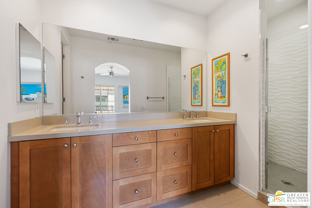 491 Terra Vita Palm Springs, CA 92262 - Photo 19 of 25 a spacious bathroom with double sink and a mirror